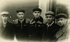 Men against the background of a closed store