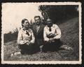 Two women and man by a waterside