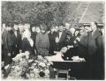 The funeral of the grandfather. The family with the coffin in the garden in front of the house