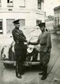 Military Men Next to a Trophy Car