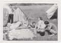 Portrait of young people near tents