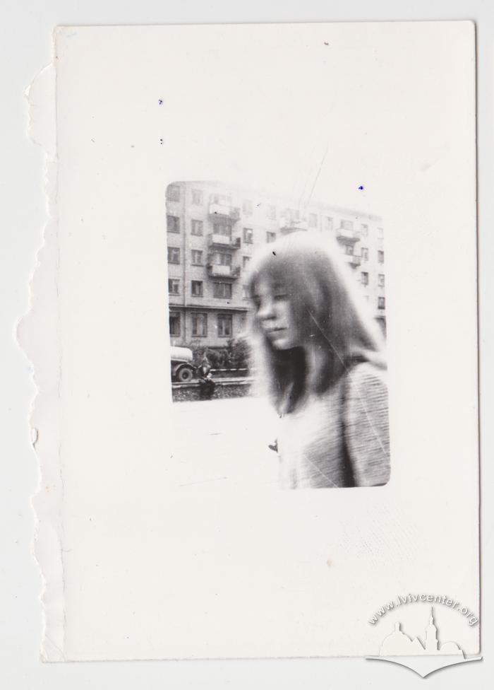 Portrait of a woman against the background of a residential building 1