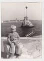 Portrait of a boy against the backdrop of the Monument to Sunken Ships